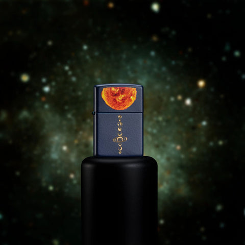 Lifestyle image of Solar System Design Navy Matte Windproof Lighter standing on a black platform with a galaxy background.