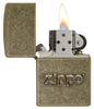 Zippo Stamp Antique Brass Lighter with its lid open and lit