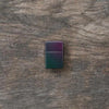 Lifestyle image of Iridescent Windproof Lighter laying flat on a wooden surface