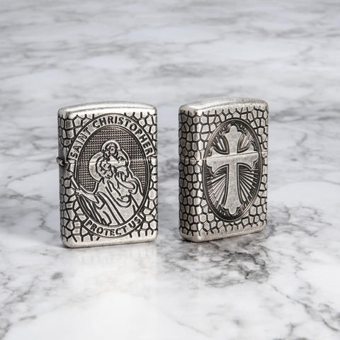 Lifestyle image of Armor St. Christopher Medal Antique Silver Windproof Lighter standing on a marble surface