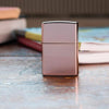 Lifestyle image of High Polish Rose Gold standing on a desk with books in the background