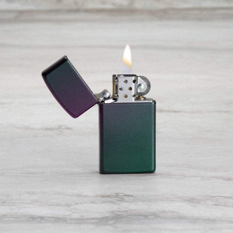 Lifestyle image of Slim® Iridescent Windproof Lighter with its lid open and lit