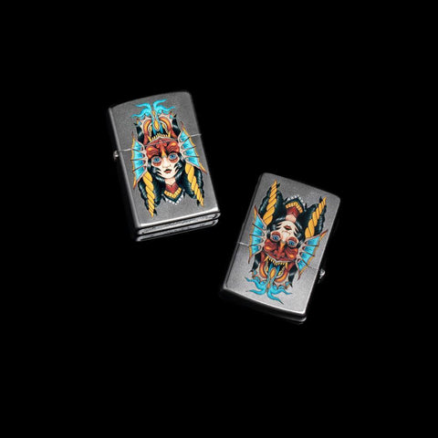 Lifestyle Image of the Two Face Design Lighter showing the lighter facing upward and downward showing two different designs on a black background