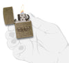 Zippo Stamp Antique Brass Lighter lit in hand