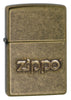 Front shot of Zippo Stamp Antique Brass Lighter standing at a 3/4 angle