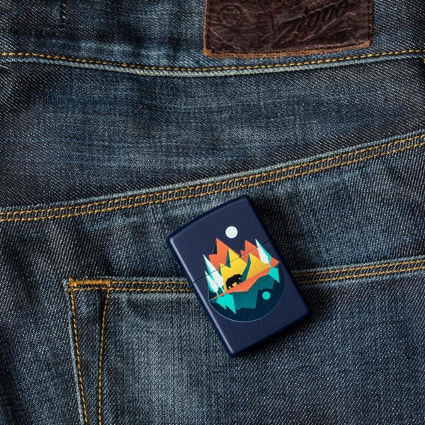 Lifestyle shot of the Geometric Bear and Mountains Design Lighter laying on a denim background