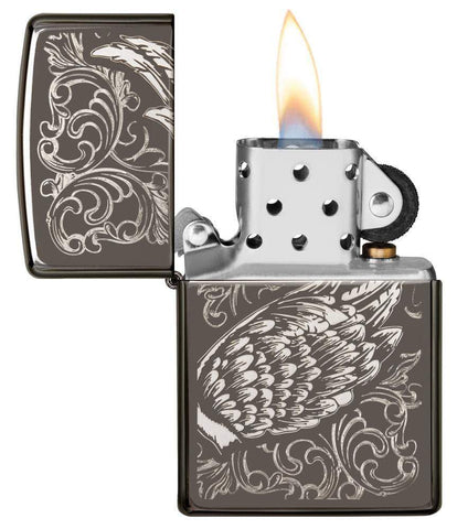 Filigree Flame and Wing Design with its lid open and lit