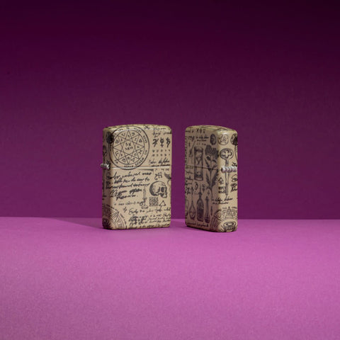 Lifestyle image of two Zippo Alchemy 540 Color Design Pocket Lighters standing in a purple scene, one lighter is showing the front of the design while the other shows the back.