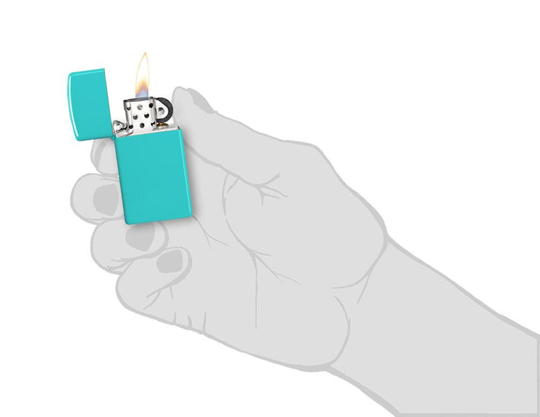 Slim® Flat Turquoise Windproof Lighter lit in hand.