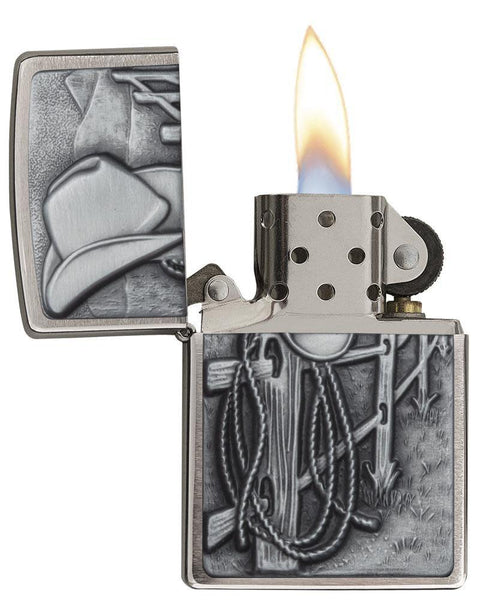 Resting Cowboy Windproof Lighter with its lid open and lit