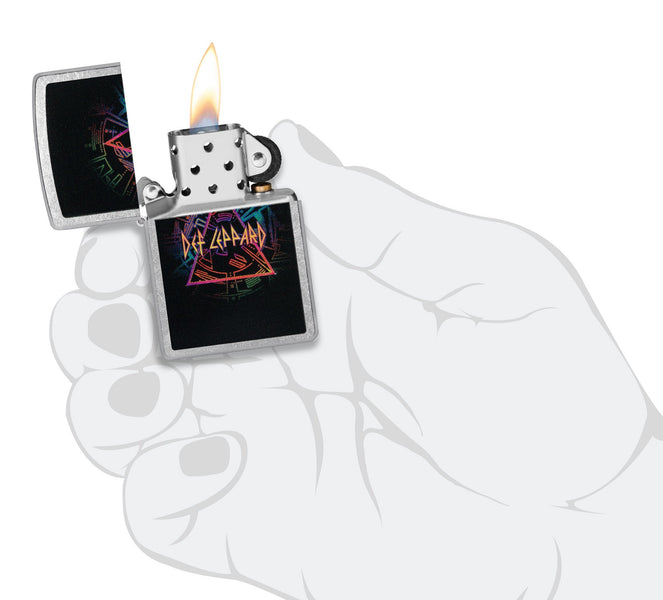 Def Leppard Design Street Chrome™ Windproof Lighter lit in hand.