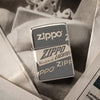 Front view of the Zippo Logo Design laying on a pile of newspaper