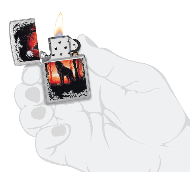 Zippo Wolf Moon Trees Windproof Lighter lit in hand.