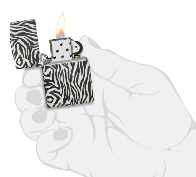 Zebra Print Design 540 Color Windproof Lighter lit in hand.