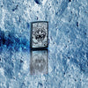 Lifestyle image of Anne Stokes Wolf High Polish Black Windproof Lighter standing on a reflective blue iced background