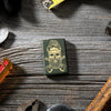 Lifestyle shot of Outdoor Skull Design Green Matte Windproof Lighter laying with tools