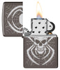 Zippo Skull Spider Design Windproof Lighter with its lid open and lit