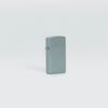 Lifestyle image of Slim® Flat Grey Windproof Lighter standing in a grey background.
