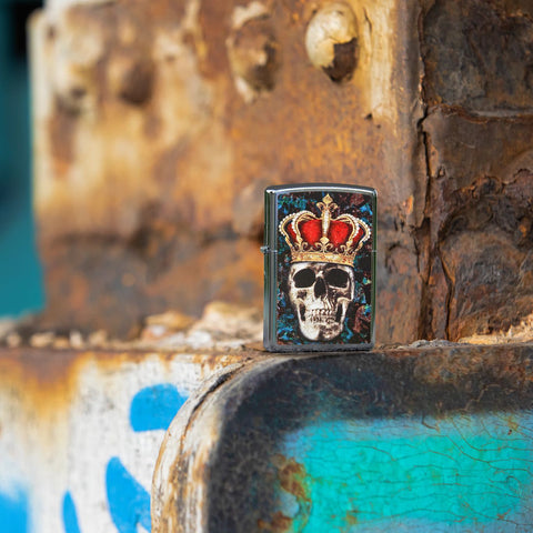 Lifestyle image of Skull King Design Street Chrome™ Windproof Lighter standing in a graffiti scene. 