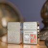Lifestyle image of Zippo 2022 Founder's Day Collectible Windproof Lighters standing on a desk.
