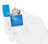 Whale Design High Polish Blue Windproof Lighter lit in hand.