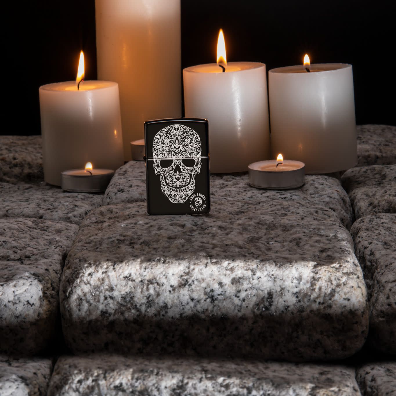 Lifestyle image of Anne Stokes Fancy Skull Lighter standing on cobblestone with lit candles in the background